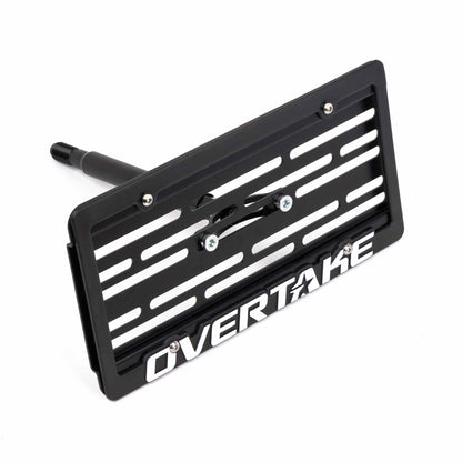 A Subaru license plate relocation kit with the brand name Overtake visible, designed for Subaru vehicles.