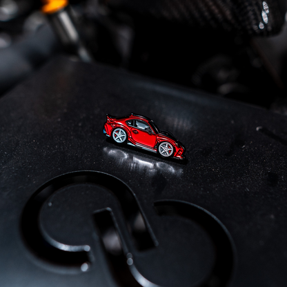 Red car model on a black surface with a blurred background