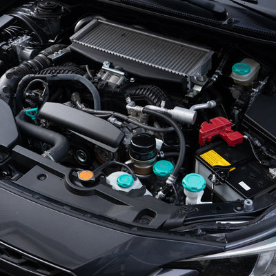 A set of four red anodized aluminum engine bay caps with engravings, including oil cap, wiper fluid cap, coolant overflow cap, and brake fluid cap symbols.