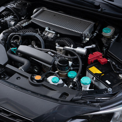 A set of four red anodized aluminum engine bay caps with engravings, including oil cap, wiper fluid cap, coolant overflow cap, and brake fluid cap symbols.